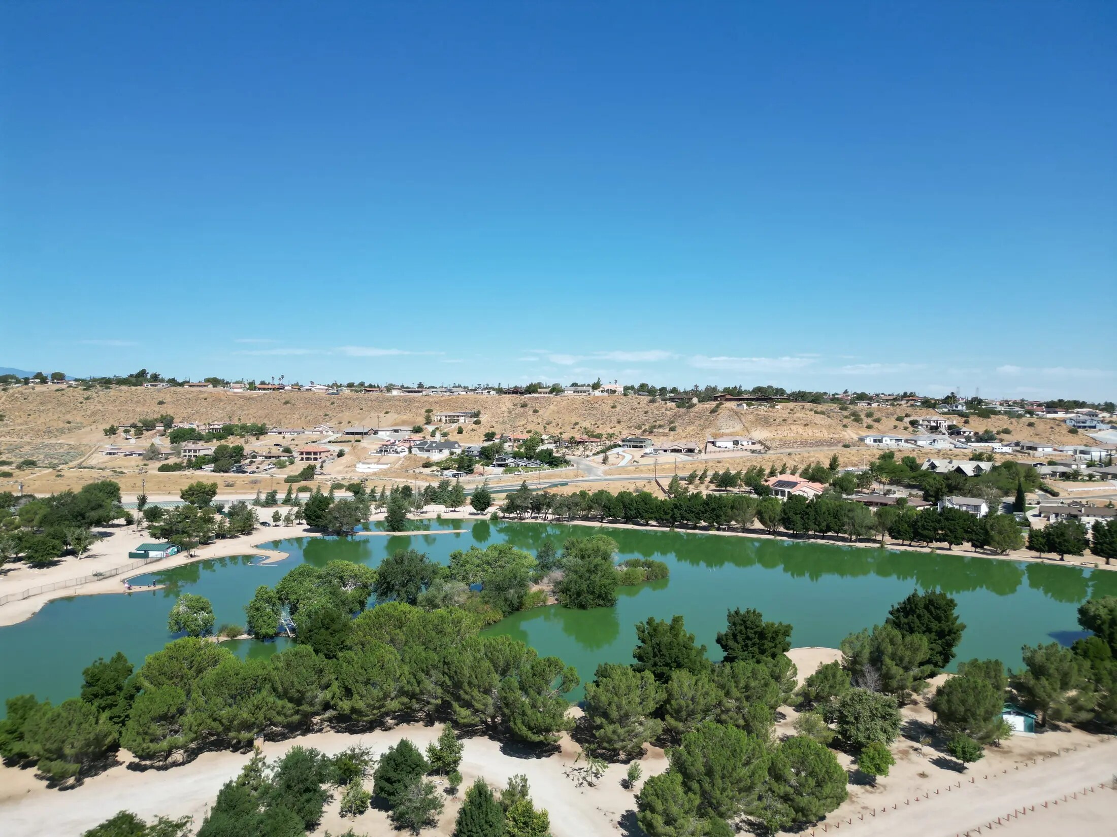 High Desert aerial overview with a lake, roads, terrain, and nearby properties
